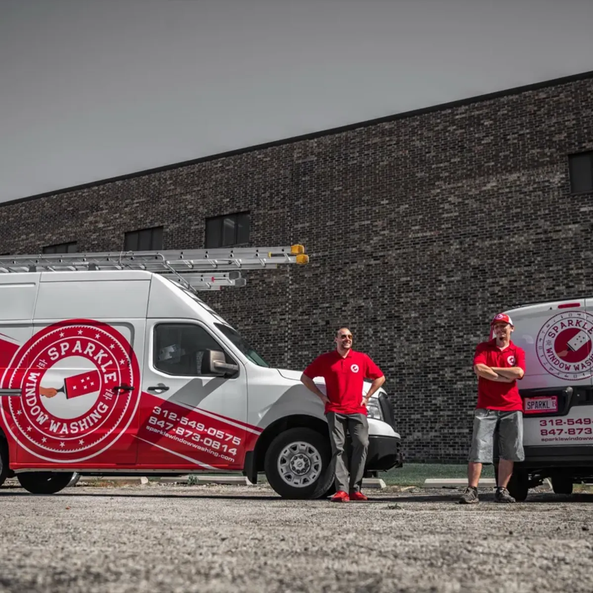 Sparkle Service team members standing with branded service vans