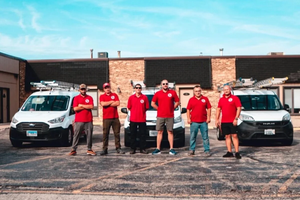 Sparkle Service technician cleaning windows on a North Shore home