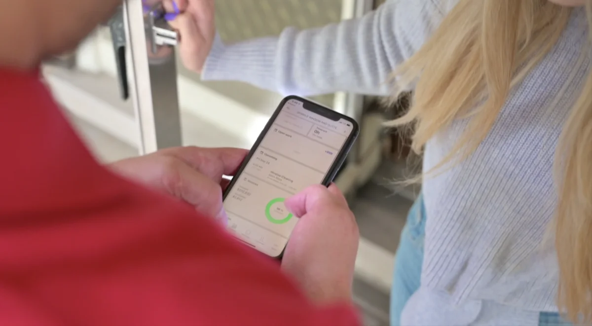 Sparkle Service technician scheduling maintenance visit with homeowner