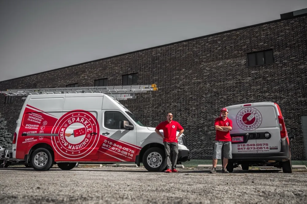 The Sparkle Service crew standing with company vans at the Northbrook facility