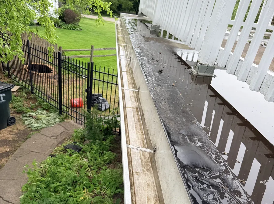 The same gutter run cleared and flowing after cleaning