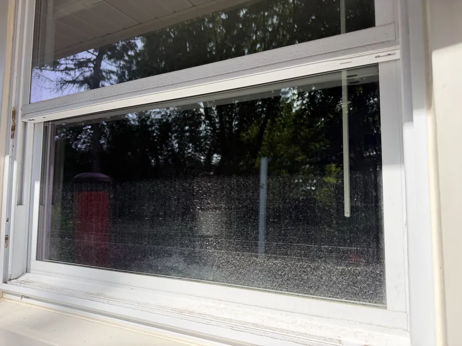 Home window before cleaning, glass spotted and hazy