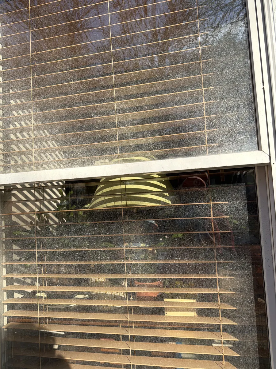 Window before cleaning, mineral spots across the glass