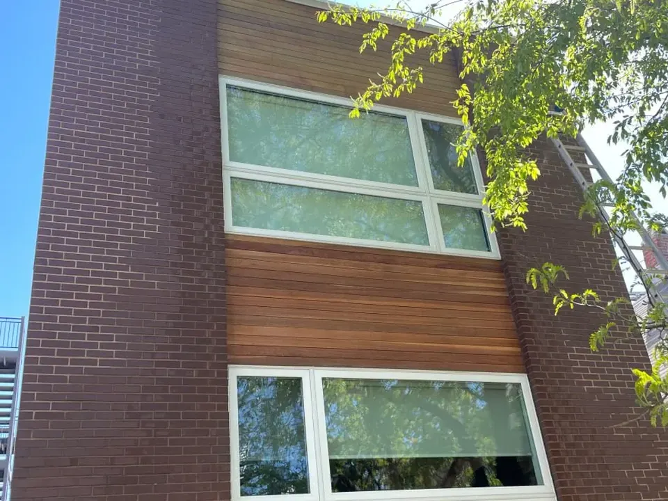 The same wood siding after a soft wash, the boards back to a warm gold